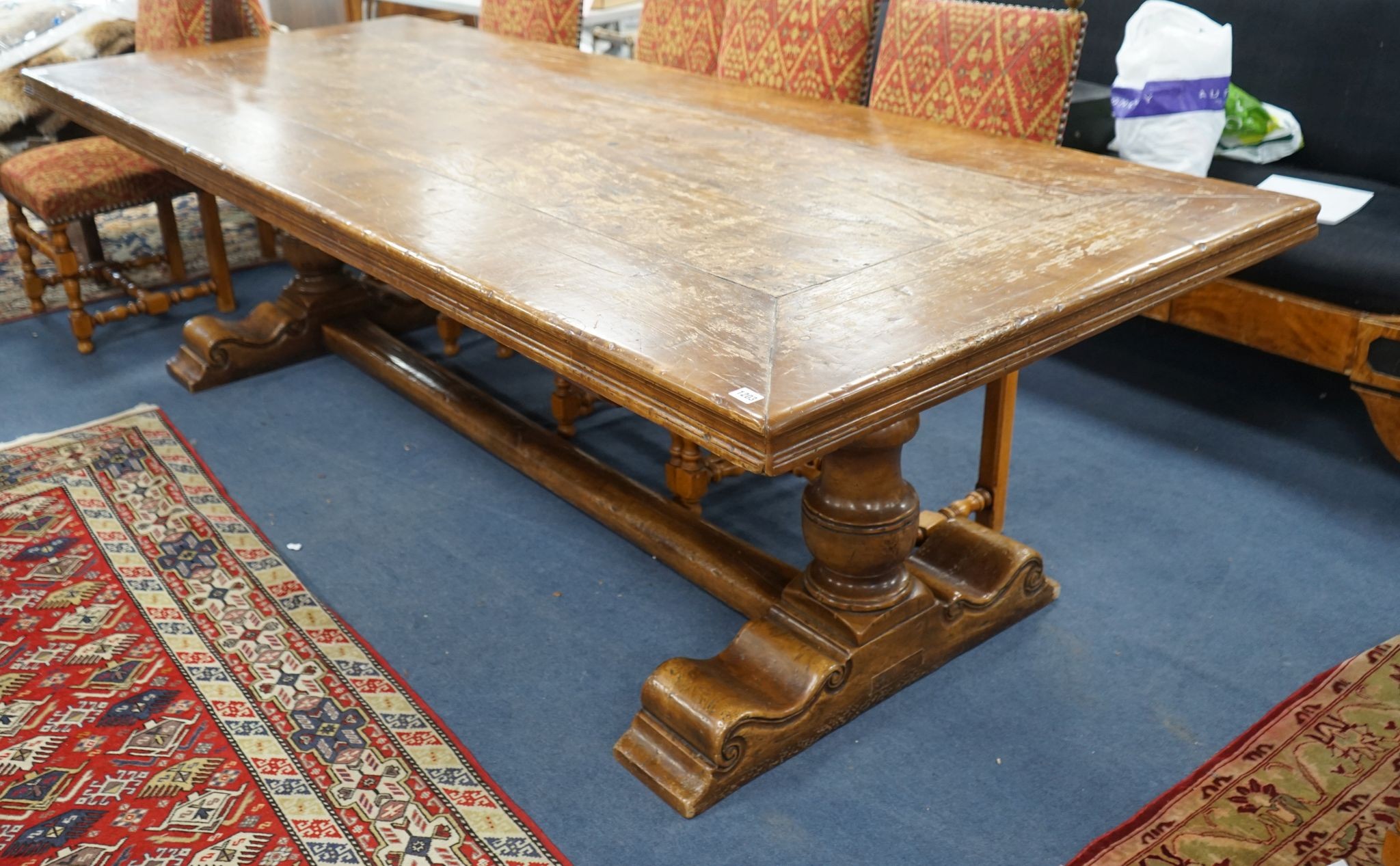 An 18th century style rectangular walnut refectory dining table on baluster end supports with central stretcher, length 270cm, width 106cm, height 76cm